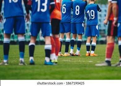 Football Players Standing In A Wall During Free Kick. Soccer League Match Of Youth Teams