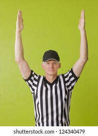 Football Referee Against Green Background Signaling A Touchdown, Three Quarter Length,