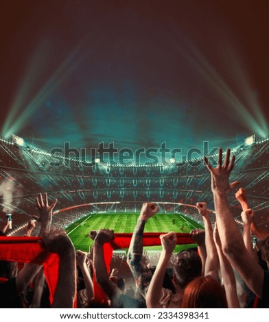 Football scene at night match with with cheering fans at the stadium