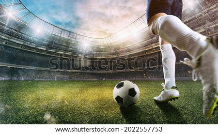 Football scene at the stadium with close up of a soccer shoe kicking the ball