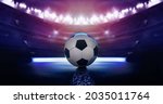  football or soccer ball against black background in neon light