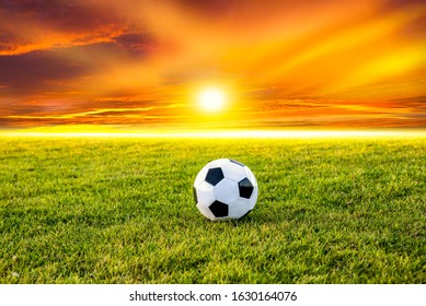 Football Or Soccer Ball At The Kickoff Of A Game With Sunset 