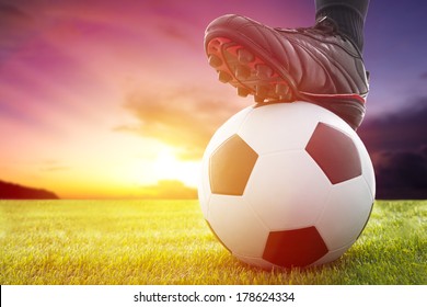 Football or soccer ball at the kickoff of a game with sunset - Powered by Shutterstock