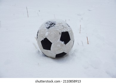 A football, soccer ball, football ball, on snow  - Shutterstock ID 2110858913