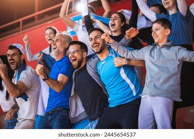 Football  soccer fans are cheering for their team at the stadium on the match - Powered by Shutterstock