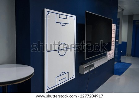 Football or soccer field white board in home dressing room with tv to discuss tactic before kick off or during half time break