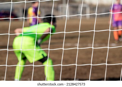 Football Soccer Goalkeeper With Color Uniform, From Behind View.
