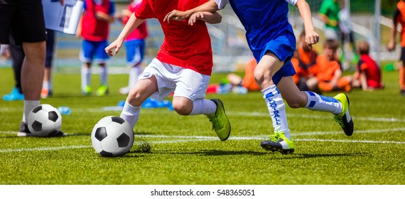 Football Soccer Match for Children. Kids Playing Soccer Game Tournament. Boys Running and Kicking Football. Youth Soccer Coach in the Background - Shutterstock ID 548365051