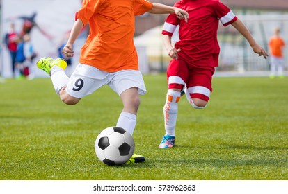 Football Soccer Match For Children. Kids Playing Soccer Game Tournament. Boys Running And Kicking Football. Youth Soccer Footballers Competition