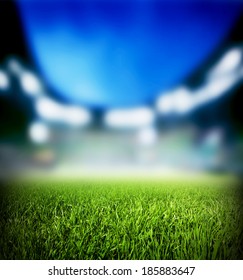 Football, Soccer Match. Grass Close Up. Night Event Lights On The Stadium.