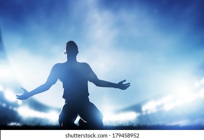 Football, soccer match. A player celebrating goal, victory. Lights on the stadium at night. - Shutterstock ID 179458952
