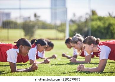 Football, soccer and plank exercise drill of girls training team working on a fitness workout. Focus, motivation and teamwork collaboration of sports group of students on a school sport grass field - Powered by Shutterstock