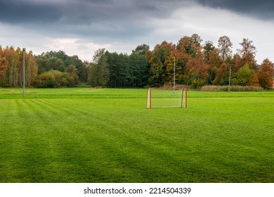 A Football (soccer) Training Ground In A Rural Autumn Landscape. Perfectly Trimmed Lush Green Grass. 
A Beautifully Situated Football Field. Polanka Wielka, Poland