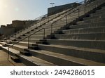 Football stadium bleachers in late afternoon sun