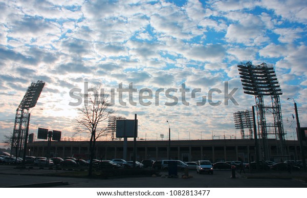 Football Stadium Silhouette\
and Parking Lot with Cars on Sunset in Saint Petersburg, Russia.\
Petrovsky Football Stadium, Soccer Sports Complex Concept\
Wallpaper.
