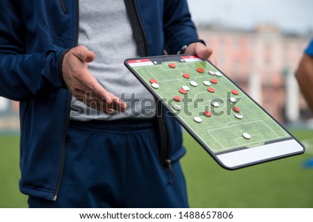 Football tactic education. Coach explains the strategy of the game