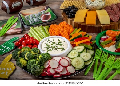 Football Tailgate Themed Party Food Display With Vegetable Platter With Ranch Dressing Dip, Meat, Cheese And Cracker Tray With Spinach Artichoke Dip Ready For Game Day