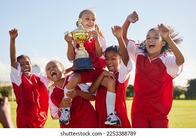 Football, team and trophy with children in celebration together as a girl winner group for a sports competition. Soccer, teamwork and award with sport player kids celebrating success outdoor - Powered by Shutterstock