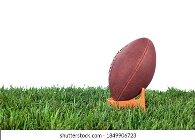 Football tee on green grass waiting for a kick off. White background for placement of copy. - Powered by Shutterstock