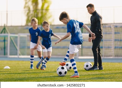 Football Training Practice Exercises for Youth Soccer Players. Boys on Training with Soccer Balls on Pitch