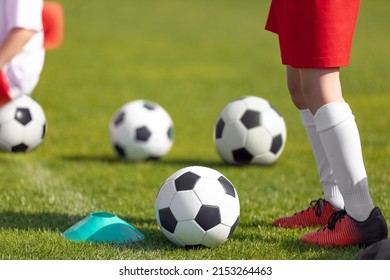 Football Training Practice For Kids. Player Running With Football Ball In Sports Grass Cleats. Training Session In Soccer For Youth Players. Kids On School Sports Venue