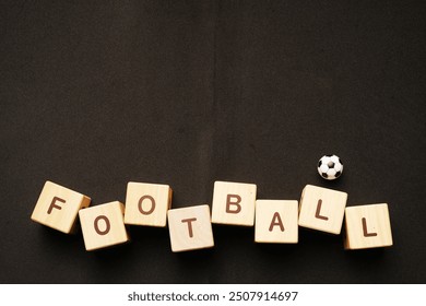 football writing from wooden cube blocks on black background - Powered by Shutterstock