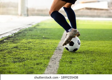 The Footballer's Feet Are Jumping And Controlling The Ball On The Artificial Turf.