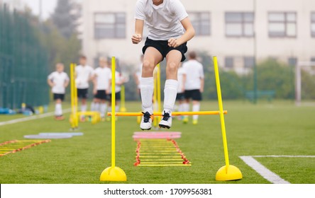 Footballers On Practice Session In Field On Sunny Day. Soccer Player On Fitness Training. Young Soccer Players At Speed And Agility Practice Training Session