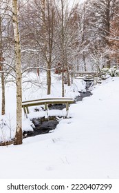 Footbridge Over A Garden Creek A Snowy Winter Day