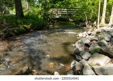 Footbridge Over Wolftrap Creek At Wolf Trap National Park For The Performing Arts. Dynamic Creek Called Wolftrap Run That Flows Through Much Of The Wooded Area Of The Park. 