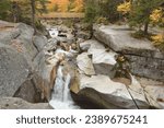 Footbridge overlooking upper falls along the Ammonoosuc River in New Hampshire’s White Mountains. At this location the river plunges downstream through a rocky gorge.