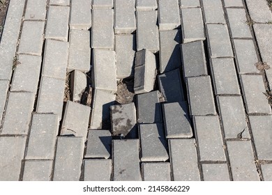 The footpath collapsed. hole in pedestrian sidewalk area. Crashed hole in cobblestone on city sreet. The collapse of paving slabs