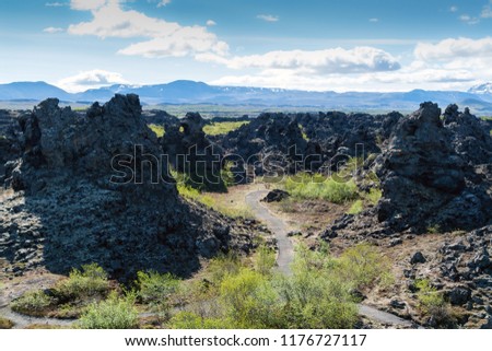 Footpath in Dimmuborgir lava field, Myvatn area - Iceland. The Dimmuborgir area is composed of various volcanic caves and rock formations, reminiscent of an ancient collapsed citadel.