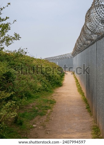 A footpath at the fence around Heysham Nuclear Power Station, Lancashire, England, UK