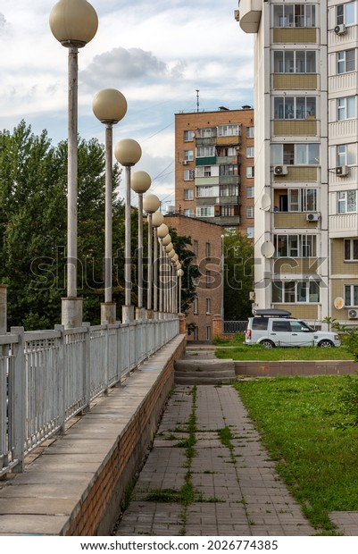 Footpath, street lights in the\
courtyard of a residential building. Moscow, Russia - August 14,\
2021.