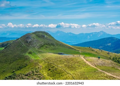 A footpath that skirts the green grassy peak of Rindernock (2024m.), Nock Mountains, Gurktal Alps, Austria.