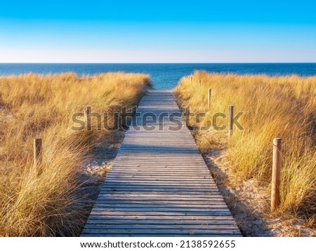 Footpath through dunes to the beach in warm evening light, Baltic See, Germany