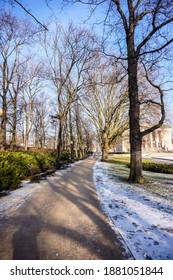 A Footpath With Trees And Grass With Snow At A Park In Poznan, Poland