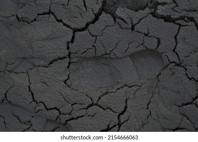 Footprint On Cracky Muddy Terrain.