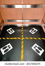 Footprint Signsymbol For Standing On Elevator Floor To Prevent Spreading Of Covid-19. Social Distance And Public Safety Concept