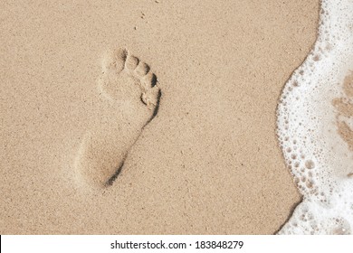 Footprint In The White Sand On The Beach