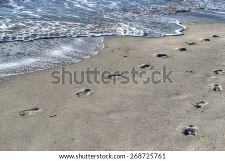 footprints by the shore in Alghero, Sardinia