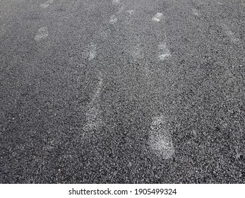 Footprints on the asphalt road