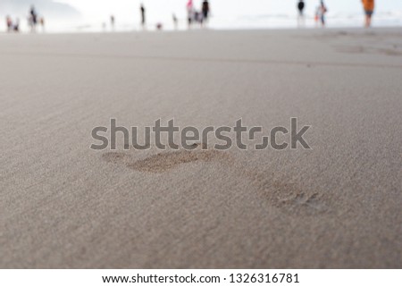 footprints on the beach in the morning at low tide