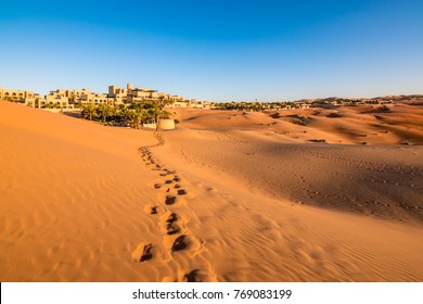 Footprints on desert sand in Abu Dhabi.