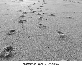 Footprints on the sand in black and white - Goa Cina Beach, Malang, Indonesia.