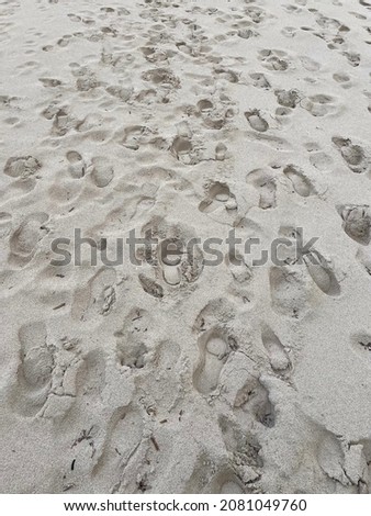 Footprints on the sand at some empty beach. Footprints texture