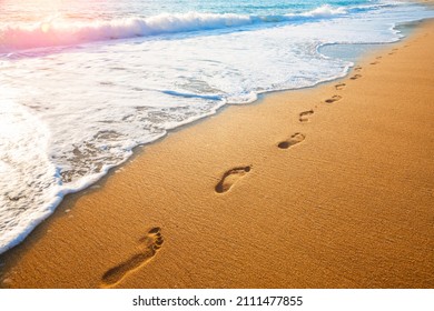 footprints on  tropical beach and beautiful  wave - Powered by Shutterstock