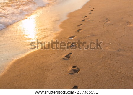 Footprints in the Sand reflective  at sunset time for background
