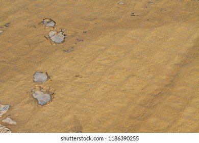 Footprints in thick brown mud after a thunderstorm. - Powered by Shutterstock